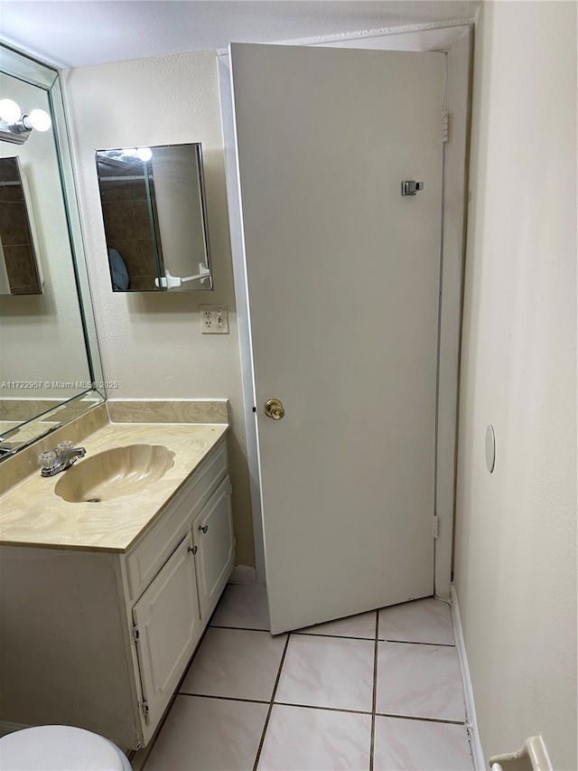 bathroom with tile patterned flooring and vanity