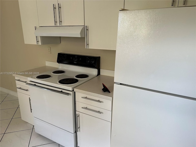 kitchen featuring white cabinets, light tile patterned flooring, and white appliances