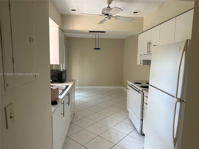 kitchen featuring white appliances, white cabinets, hanging light fixtures, ceiling fan, and light tile patterned floors