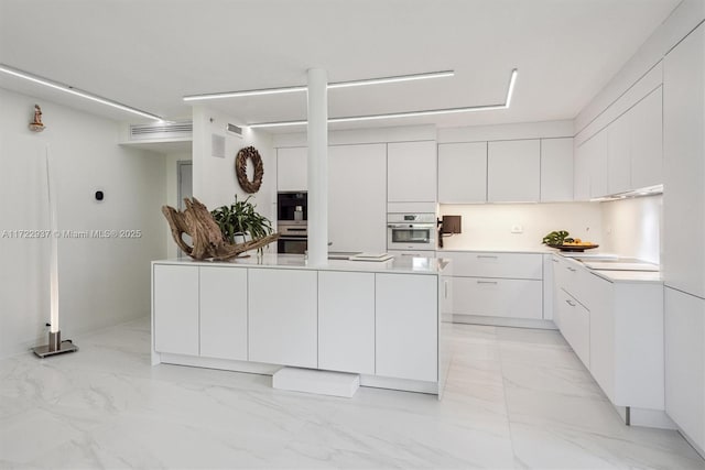 kitchen with white cabinetry and black double oven