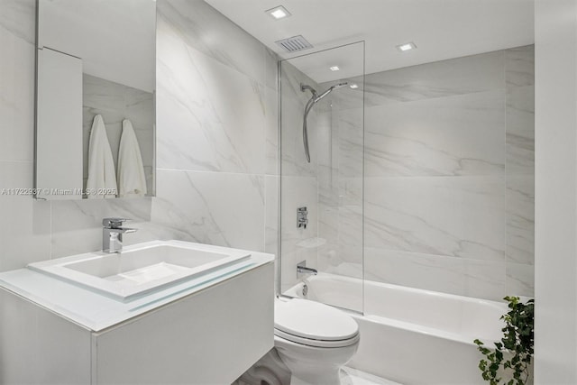 full bathroom featuring vanity, shower / bath combination, tile walls, and toilet