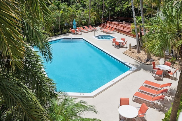 view of swimming pool with a community hot tub and a patio