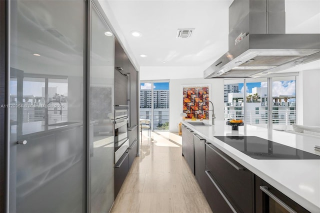 1445 16th St Unit 703, Miami Beach, FL 33139 - kitchen featuring a sink, appliances with stainless steel finishes, wall chimney exhaust hood, and modern cabinets