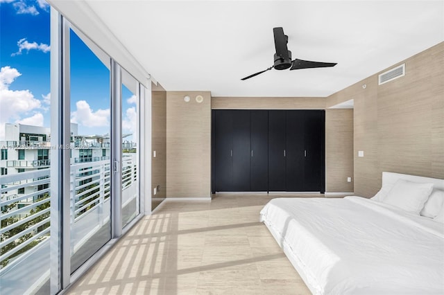 bedroom featuring ceiling fan, floor to ceiling windows, and access to outside