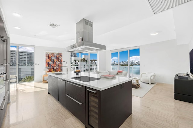 1445 16th St Unit 703, Miami Beach, FL 33139 - kitchen with modern cabinets, visible vents, open floor plan, black electric stovetop, and island range hood