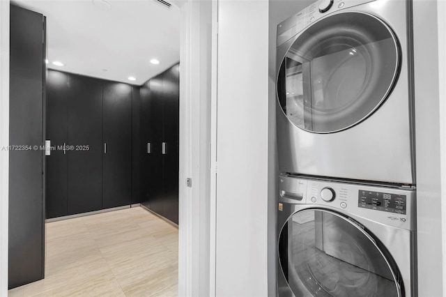 laundry area featuring stacked washing maching and dryer