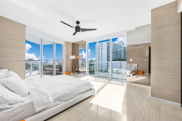 bedroom featuring ceiling fan, expansive windows, and access to exterior