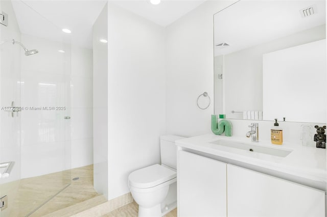 bathroom featuring a shower, vanity, and toilet