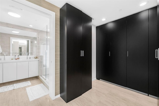 1445 16th St Unit 703, Miami Beach, FL 33139 - full bathroom with baseboards, double vanity, and a stall shower