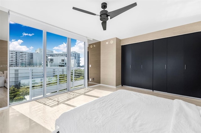 bedroom with access to outside, expansive windows, and ceiling fan