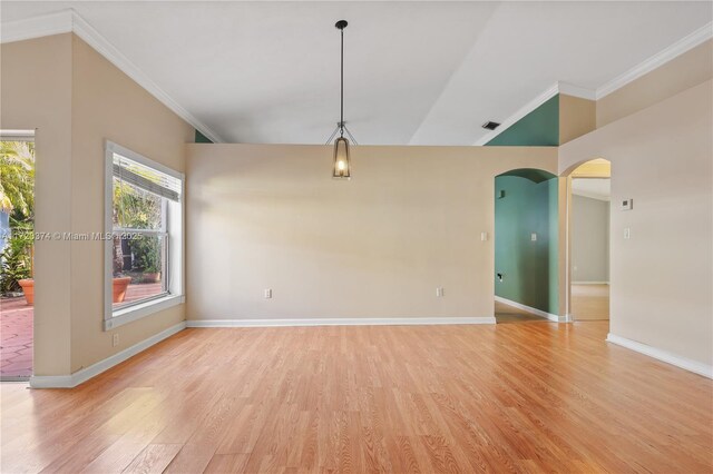 unfurnished living room featuring ceiling fan, lofted ceiling, light hardwood / wood-style flooring, and ornamental molding