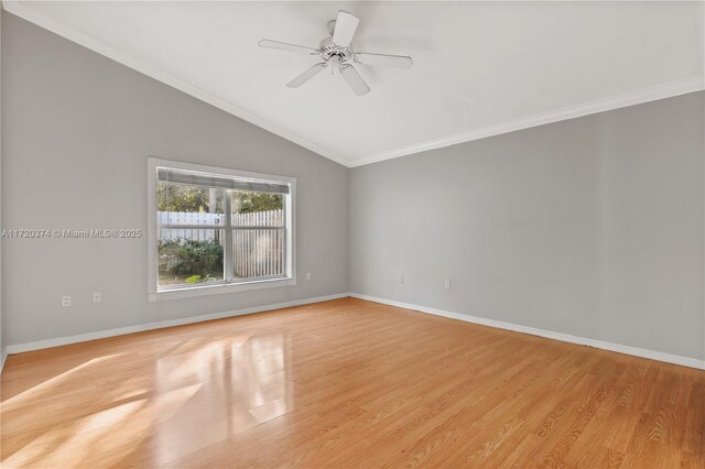 empty room featuring ceiling fan, ornamental molding, vaulted ceiling, and light wood-type flooring