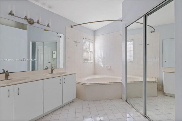 bathroom with tile patterned flooring, vanity, and separate shower and tub