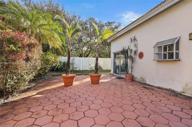 view of patio / terrace featuring fence