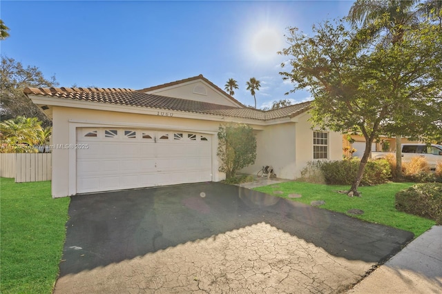 view of front facade featuring aphalt driveway, a front lawn, an attached garage, and stucco siding