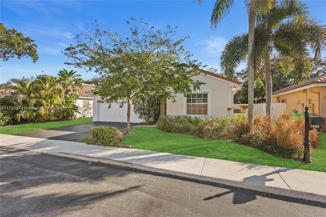 mediterranean / spanish-style house with a garage and a front yard