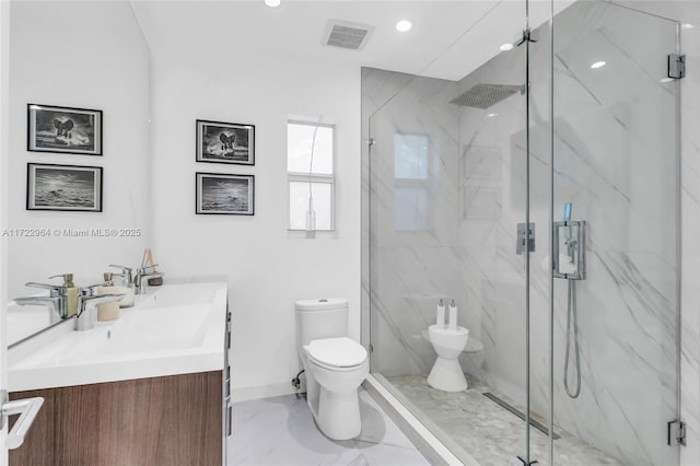 bathroom with vanity, toilet, and a shower with shower door