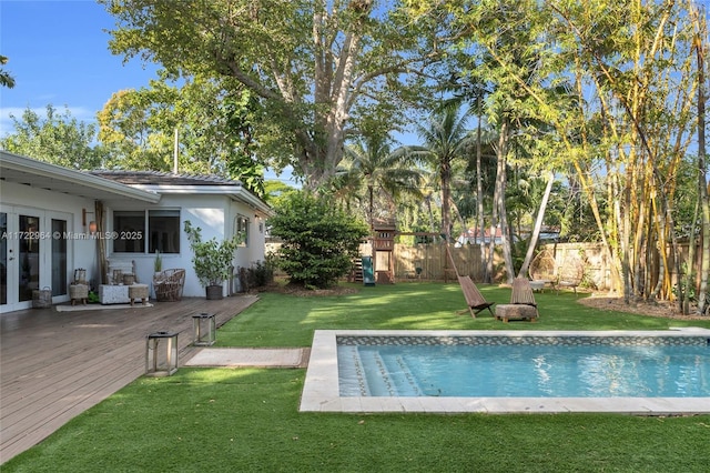 view of pool featuring a yard and french doors