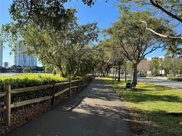 surrounding community featuring a yard and fence