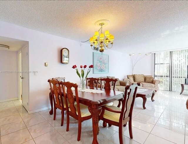 dining area with a textured ceiling, an inviting chandelier, and tile patterned floors