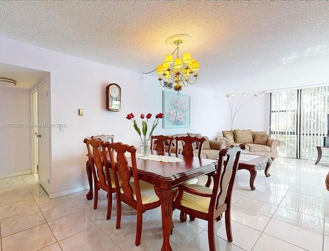 dining room featuring light tile patterned flooring, a notable chandelier, a textured ceiling, and baseboards