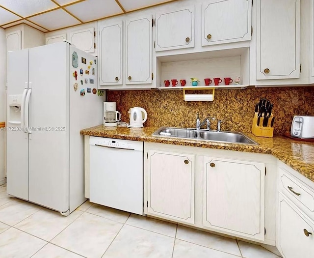 kitchen featuring white cabinets, light tile patterned floors, white appliances, and sink