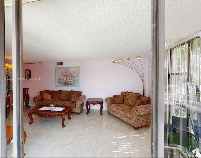 tiled living room featuring a textured ceiling