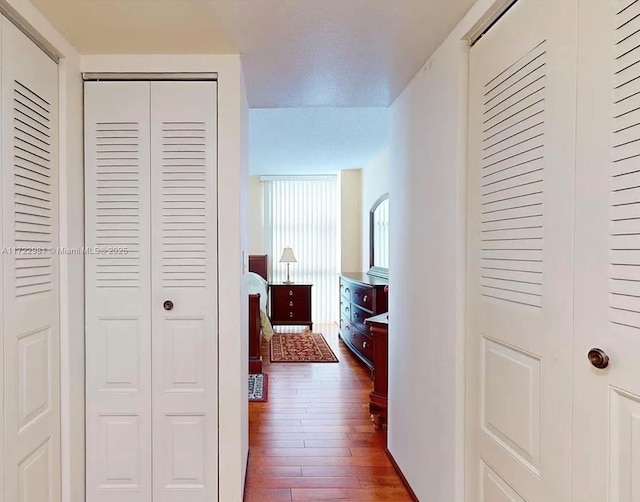 hallway with dark wood-type flooring