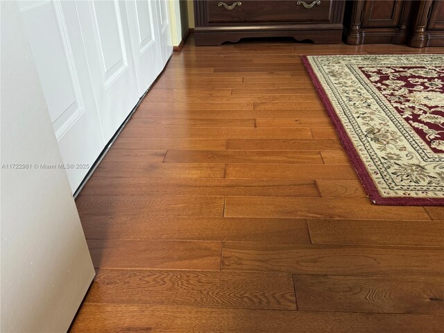 hall with hardwood / wood-style flooring