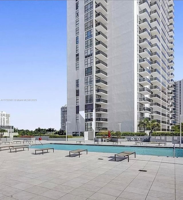 view of swimming pool featuring a view of city