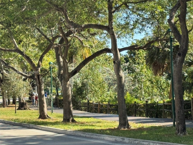 view of home's community featuring fence