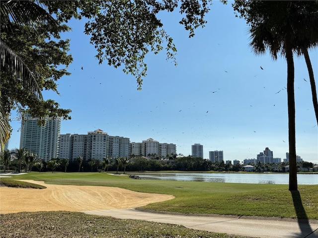 view of property's community featuring a city view, a water view, and a lawn