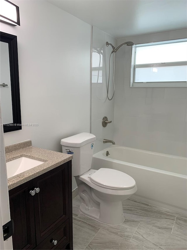 full bathroom with vanity, toilet, and tiled shower / bath combo