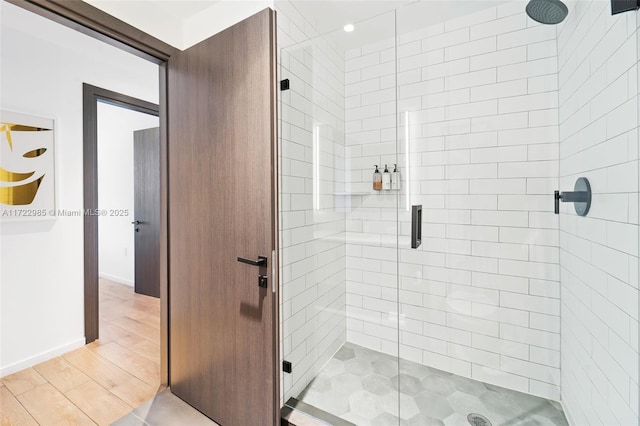 bathroom featuring hardwood / wood-style flooring and walk in shower