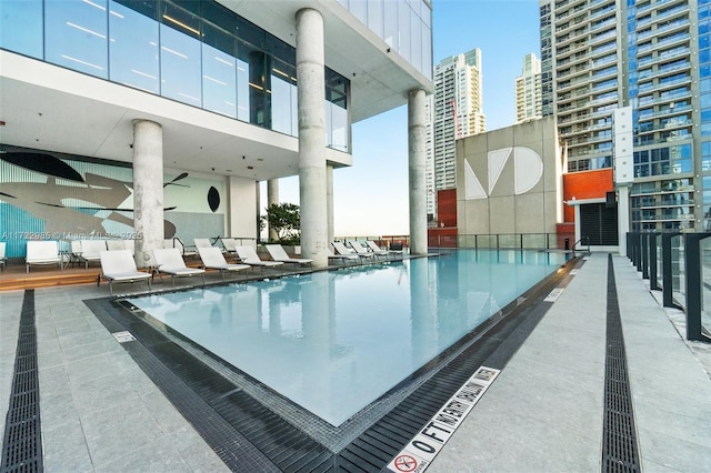 view of swimming pool featuring ceiling fan