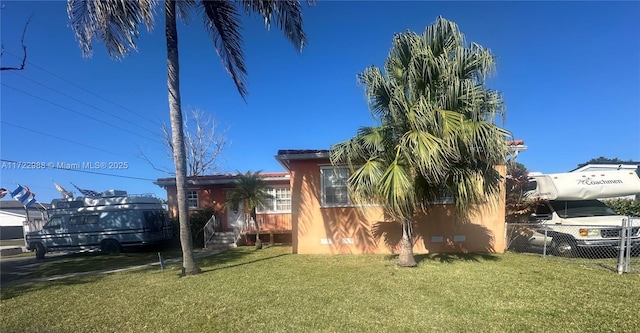 view of side of property featuring a yard