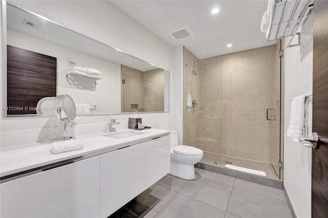 bathroom with toilet, a sink, visible vents, a shower stall, and double vanity