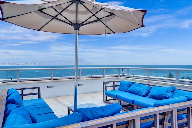 view of patio featuring a water view, a balcony, and an outdoor living space