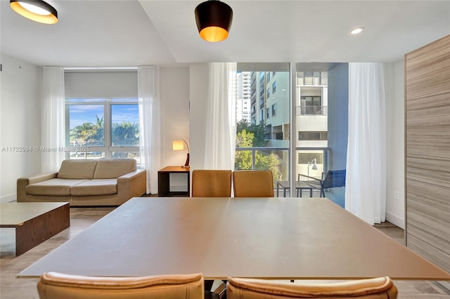 dining room featuring light wood-type flooring and recessed lighting