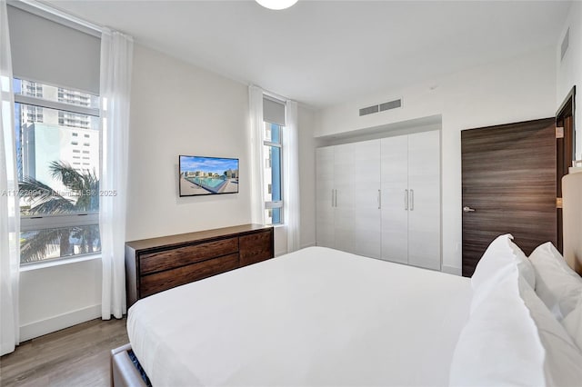 bedroom featuring light wood-type flooring and visible vents