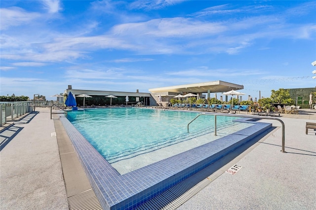 community pool featuring a patio area and fence