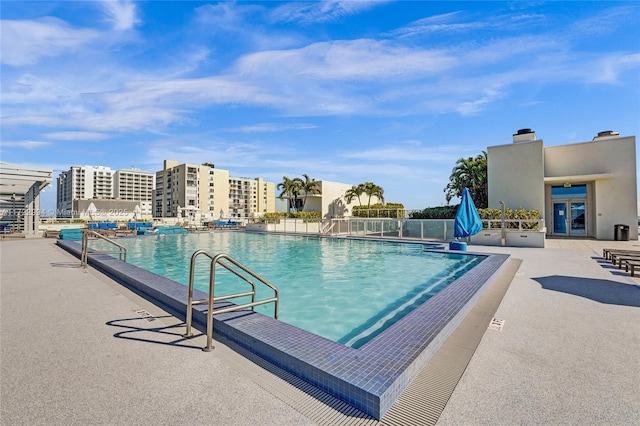 pool featuring a city view and a patio