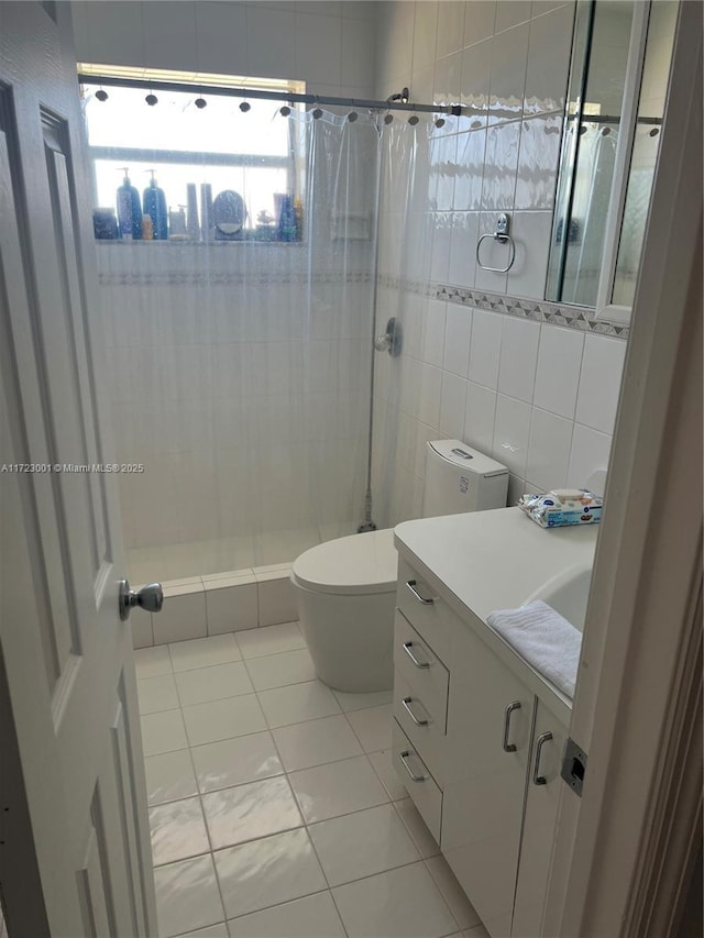 bathroom featuring vanity, tile patterned floors, a shower with curtain, toilet, and tile walls