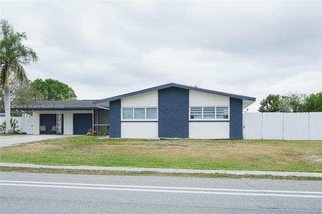 view of front of home with a front yard and a garage