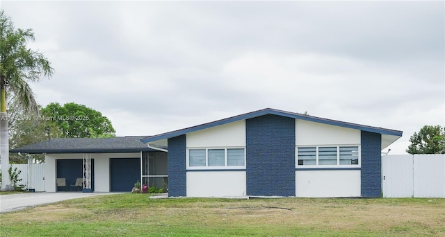 view of front of property with driveway, a front lawn, an attached garage, and stucco siding