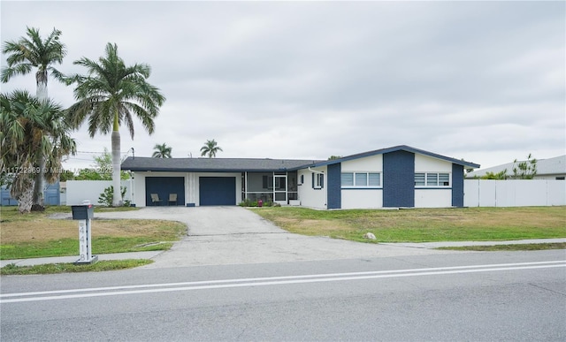 single story home featuring a garage and a front lawn