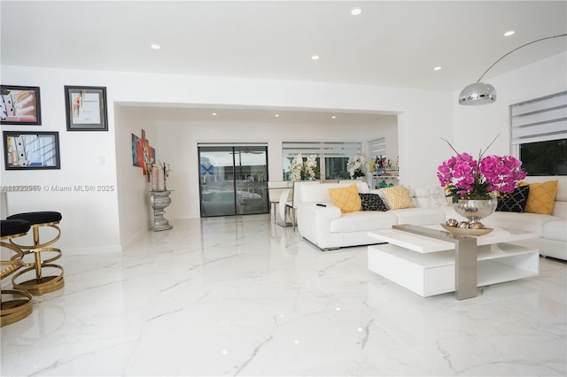 living area featuring marble finish floor and recessed lighting