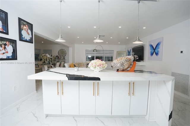 kitchen with open floor plan, marble finish floor, a spacious island, and decorative light fixtures