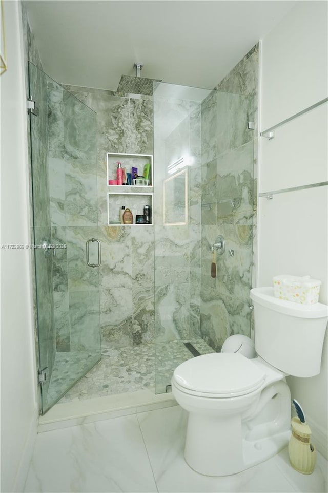 bathroom with a marble finish shower, marble finish floor, and toilet