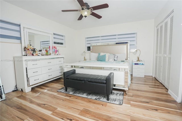 bedroom featuring ceiling fan, a closet, baseboards, and light wood-style floors